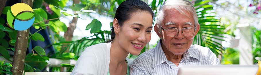 a man and his daughter smiling at a computer