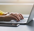 hands on a laptop keyboard